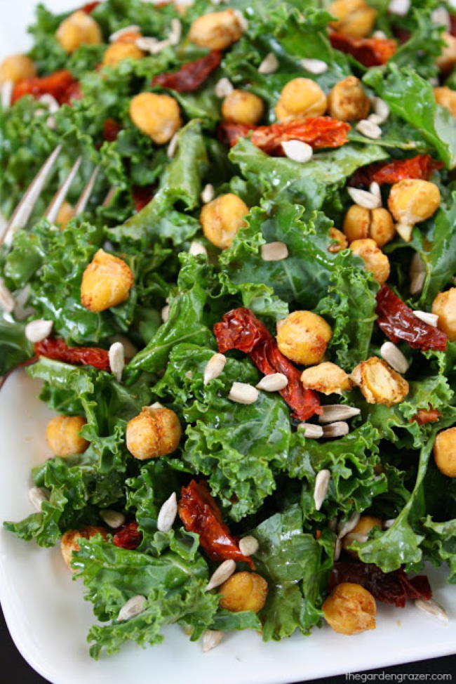 Kale Salad with sun-dried tomatoes and roasted chickpeas on a plate