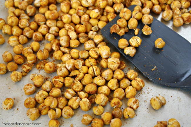 Roasted chickpeas preparation on a sheet pan with spatula