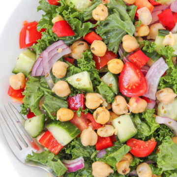 Plate of vegan kale Greek salad with marinated chickpeas