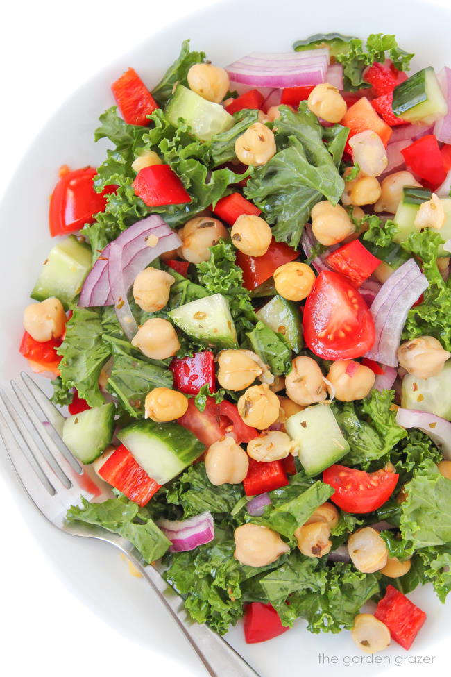 Plate of vegan kale Greek salad with marinated chickpeas