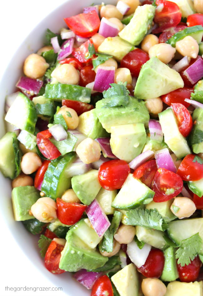 Vegan avocado tomato salad with cucumber in a bowl