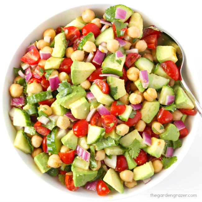 Bowl of avocado salad with tomato, cucumber, and garbanzo