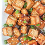 Plate of easy baked tofu cubes with sesame seeds