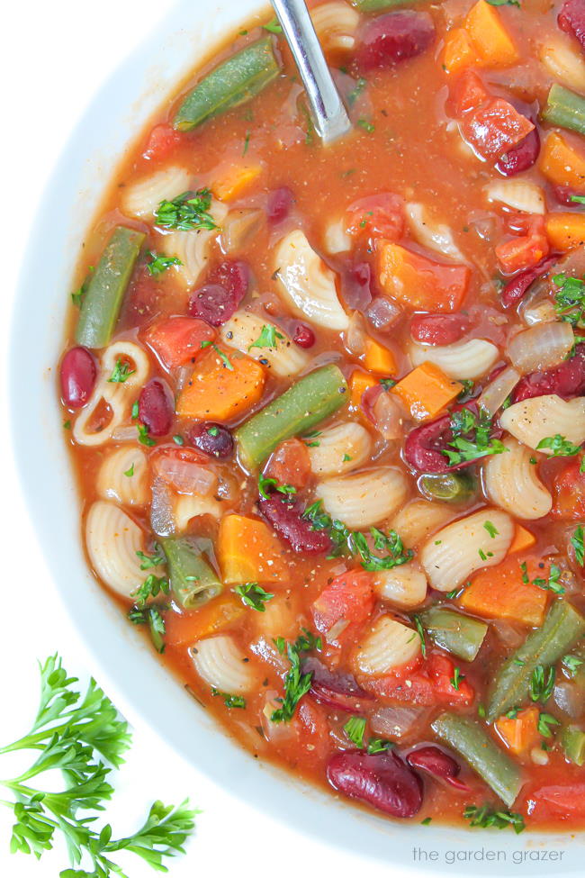 Healthy minestrone soup in a bowl with spoon