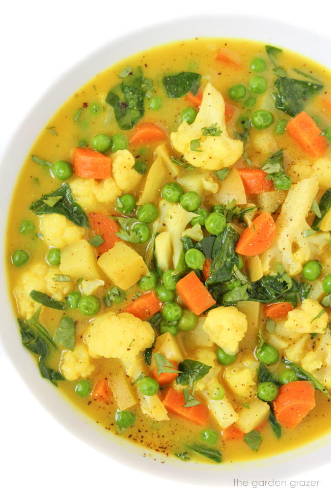 Vegan coconut curry vegetable soup in a white bowl