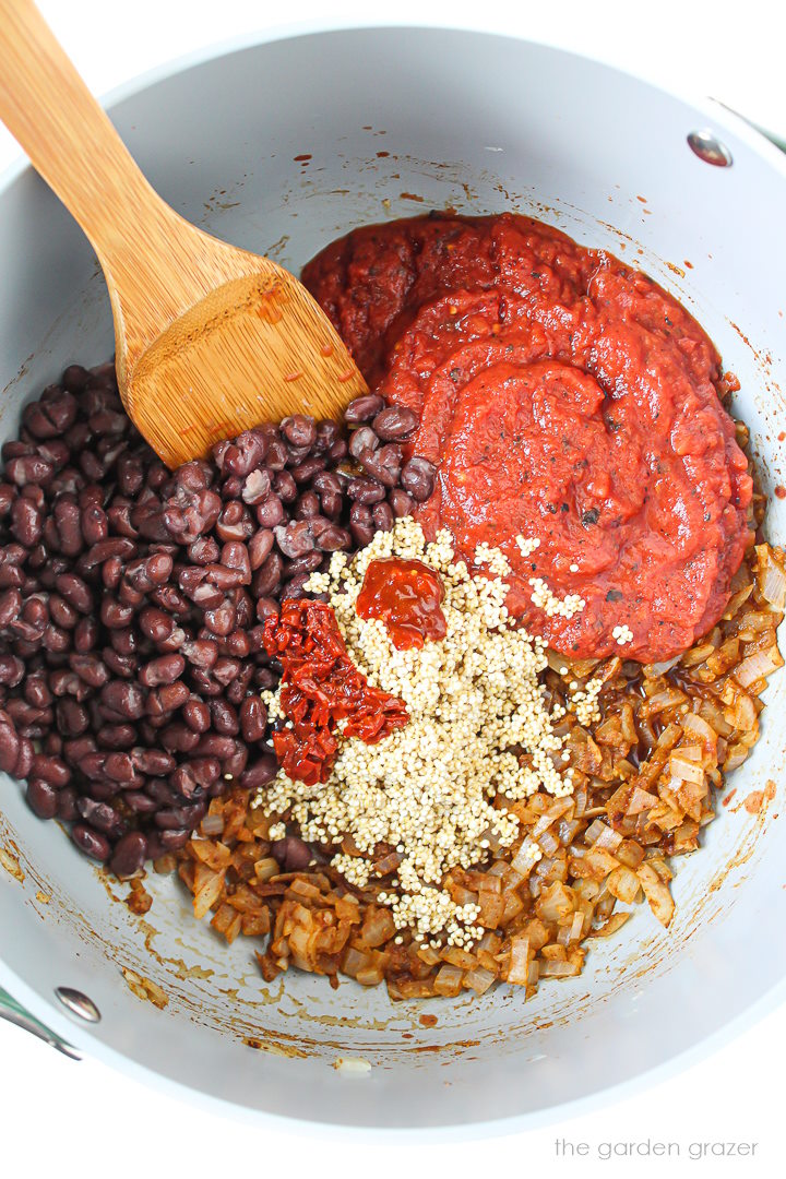 Overhead view of preparing chili ingredients together in a large pot before cooking