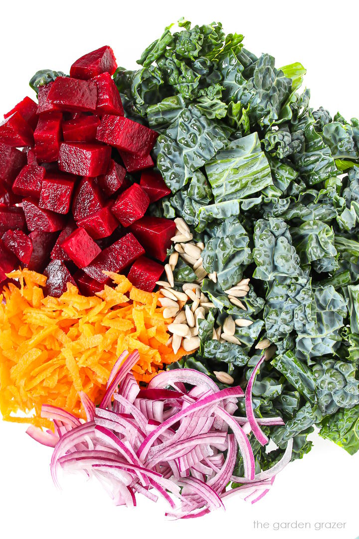 Fresh salad ingredients in a large glass bowl before tossing together