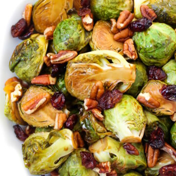 Close up view of maple balsamic glazed Brussels sprouts with dried cranberries and pecans