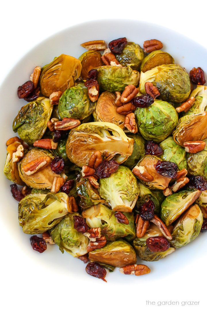 Maple balsamic glazed Brussels sprouts in a white serving bowl