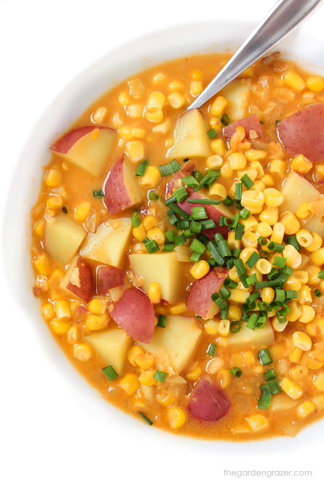 Bowl of vegan corn and potato chowder with a spoon