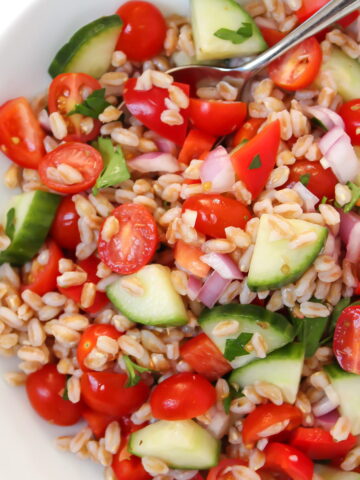 Vegan Greek farro salad in a white bowl