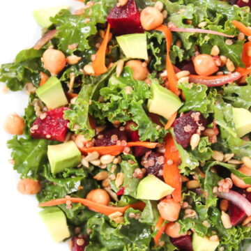 Kale superfood salad in a bowl with avocado and beets