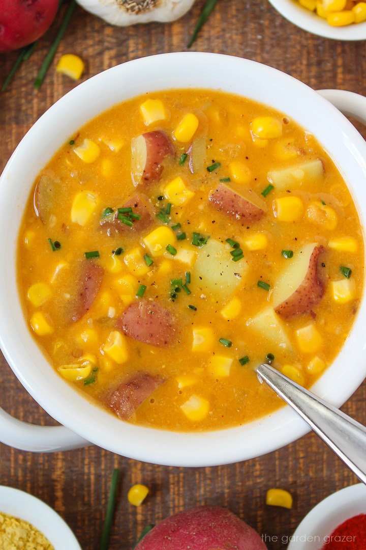 Close up view of vegan potato corn chowder in a white soup bowl