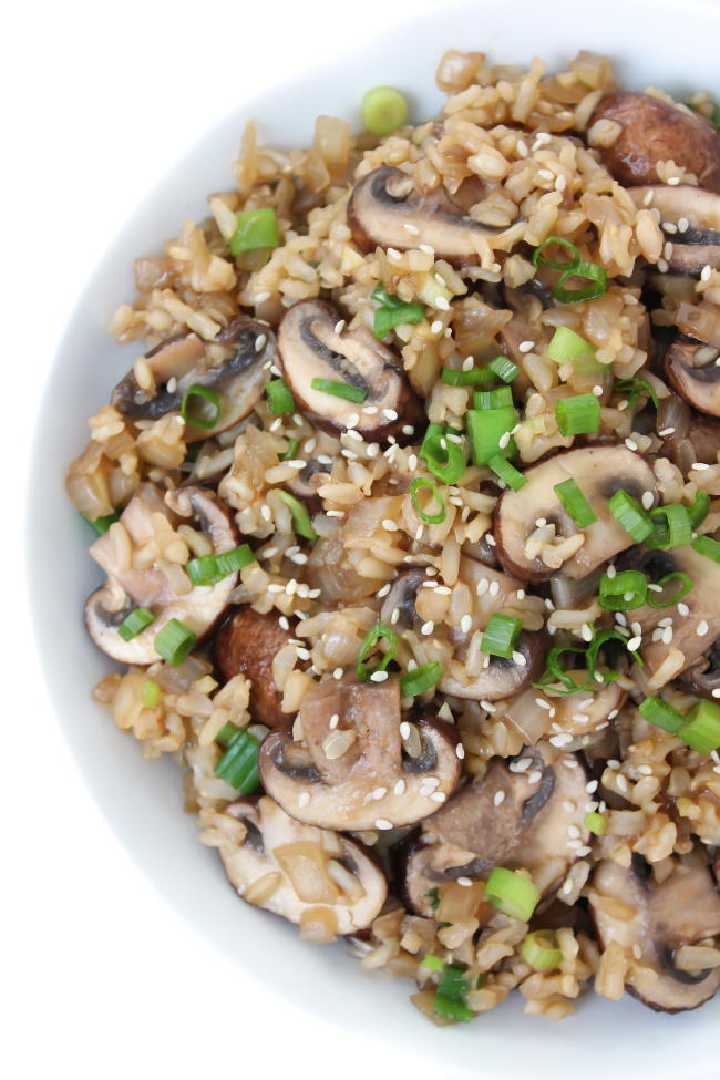 Bowl of Asian Mushroom Rice with green onions and sesame seeds