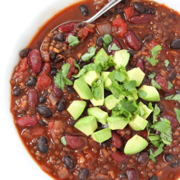 Beluga Lentil Chili in a bowl with spoon