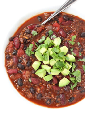 Beluga Lentil Chili in a bowl with spoon