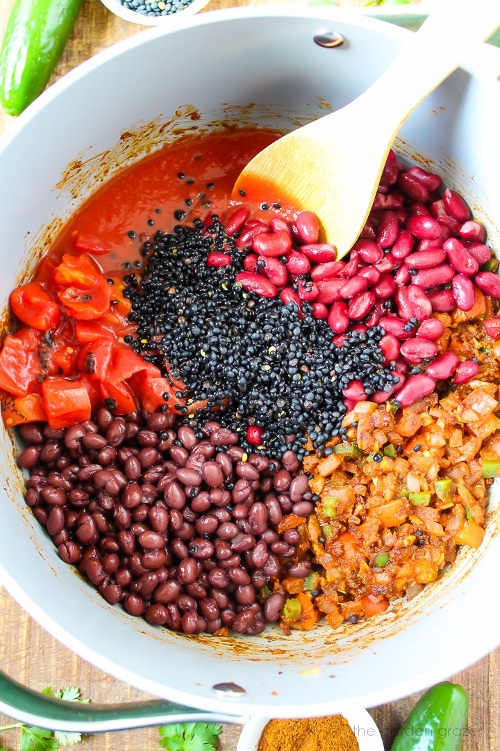 Overhead view of preparing chili ingredients in a large pot before mixing together