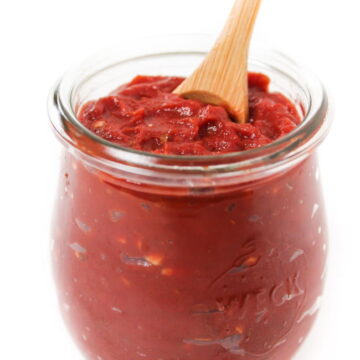 Homemade pizza sauce in a small glass jar