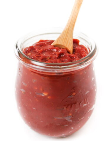 Homemade pizza sauce in a small glass jar