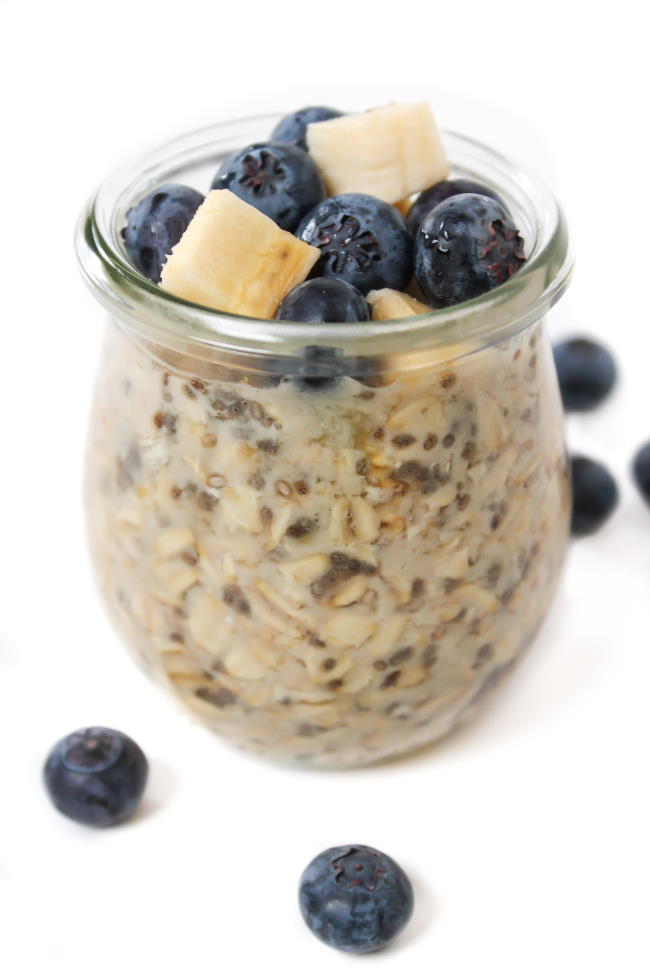 Small jar of vegan overnight oats topped with banana and blueberry