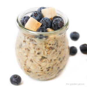 Small jar of vegan overnight oats with blueberries on top