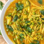 Vegan turmeric noodle soup in a bowl