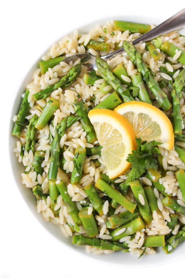 Lemon Garlic Orzo with asparagus in a bowl with spoon