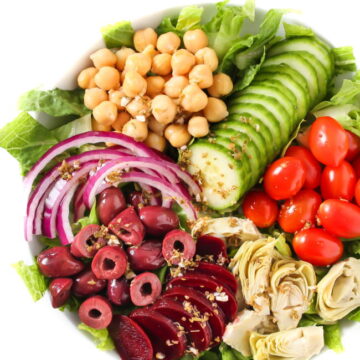 Vegan Greek Salad with dressing poured over top