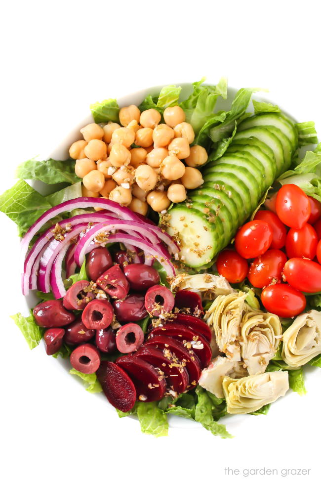 Vegan Greek Salad with dressing poured over top