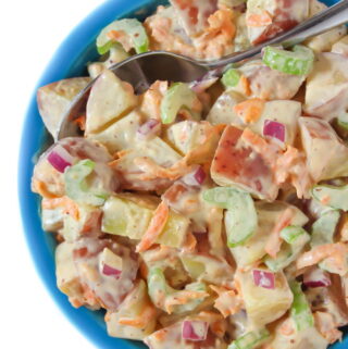 Vegan potato salad in a bowl with spoon