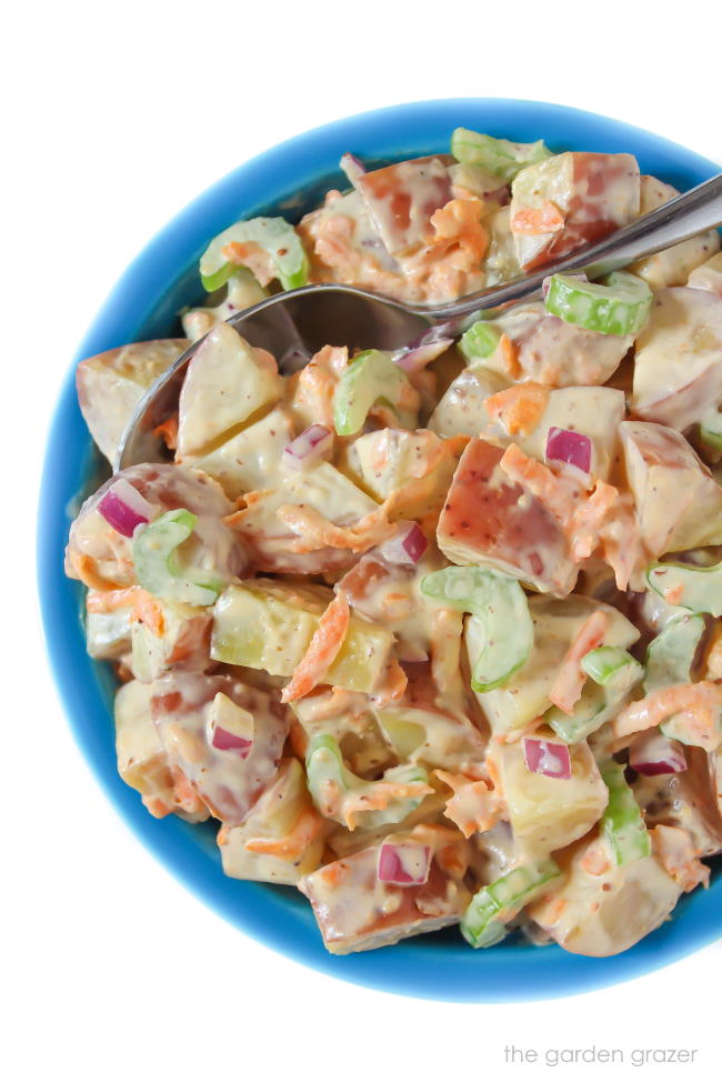 Vegan potato salad in a bowl with spoon