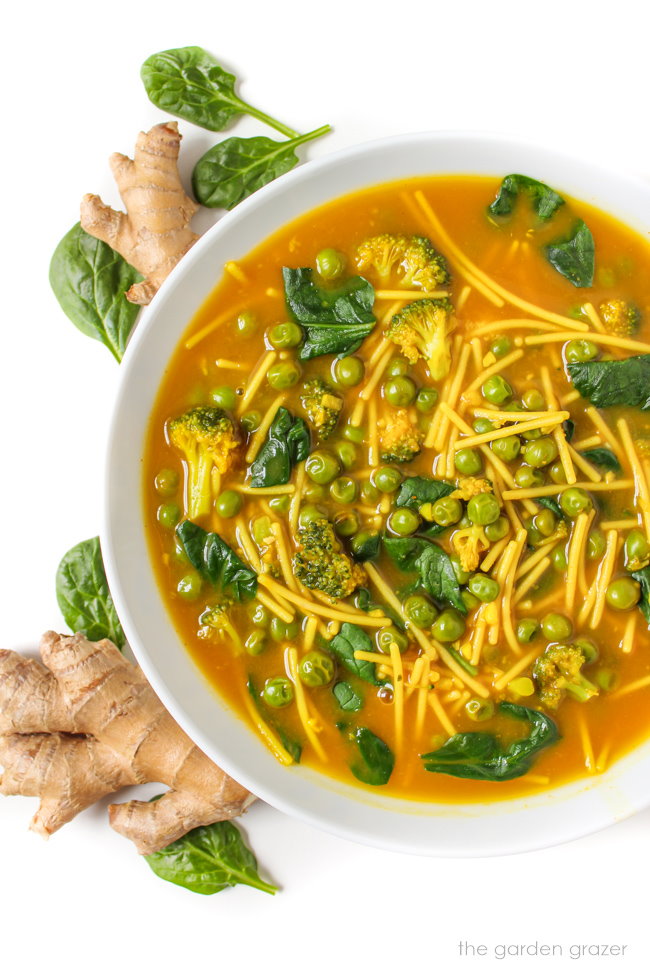 Ginger noodle soup with vegetables in a white bowl