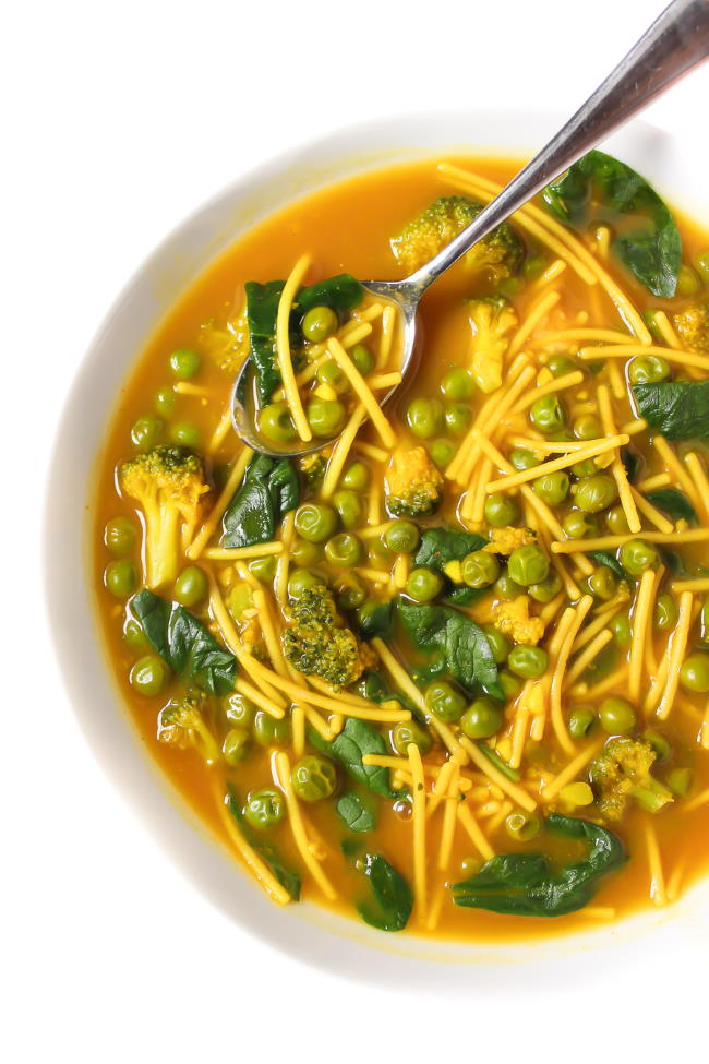 Healing turmeric noodle soup in a bowl with spoon