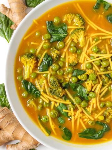 Turmeric noodle soup in a white bowl