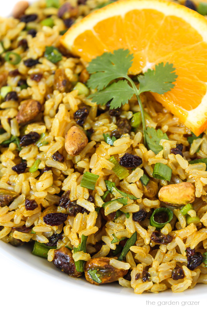 Close up view of curried rice salad in a white bowl