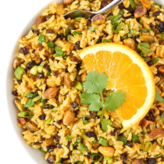 Curried Orange Rice Salad in a bowl with spoon