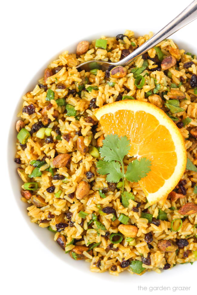 Curried Orange Rice Salad in a bowl with spoon