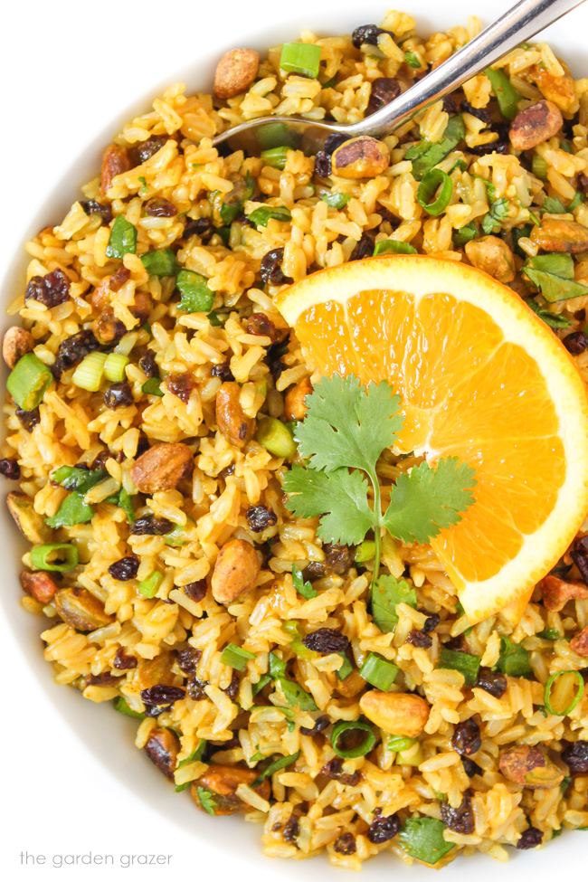 Bowl of curried rice salad with fresh orange