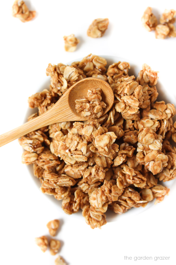 Bowl of peanut butter granola with small spoon