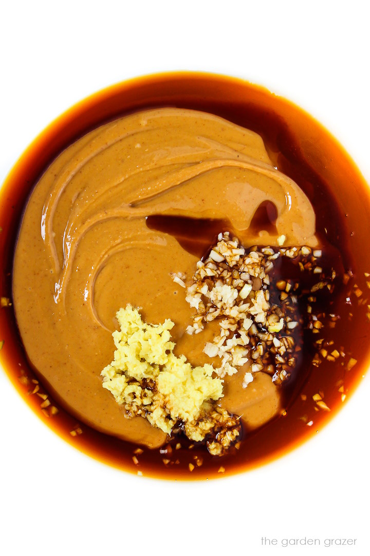 Ingredients for peanut sauce in a glass bowl before whisking together