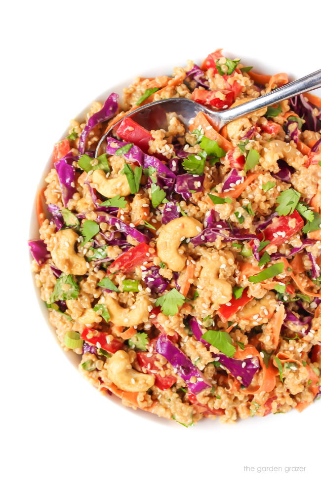 Bowl of Thai Inspired Quinoa Salad with peanut sauce