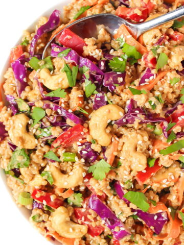 Thai quinoa salad with peanut sauce in a white bowl