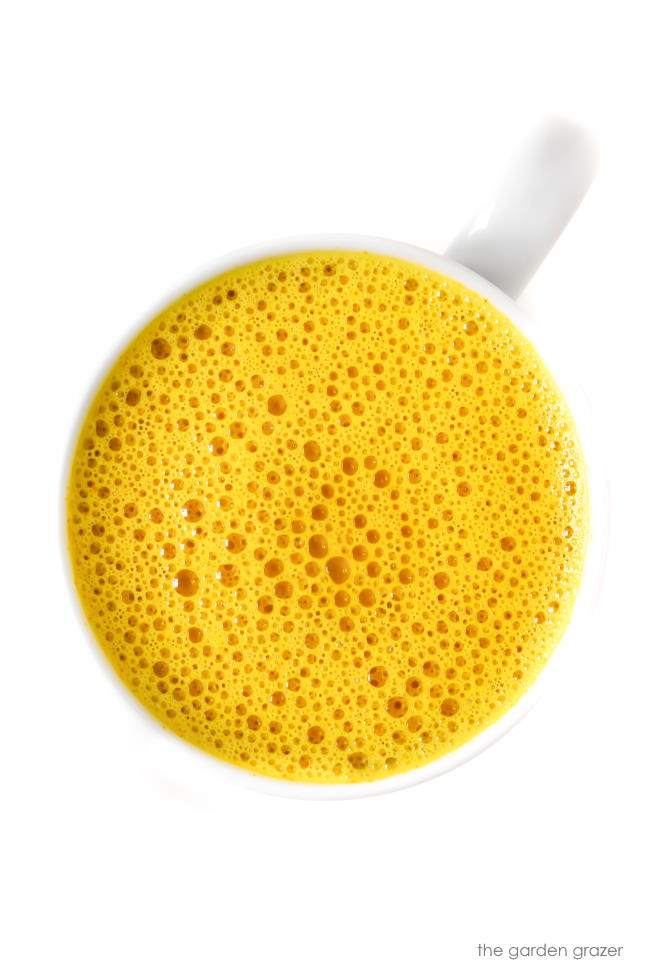 Mug of bright yellow vegan turmeric milk