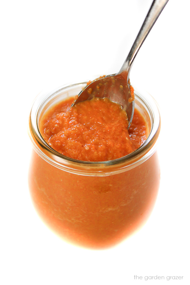 Vegan carrot ginger miso dressing in a glass jar with spoon