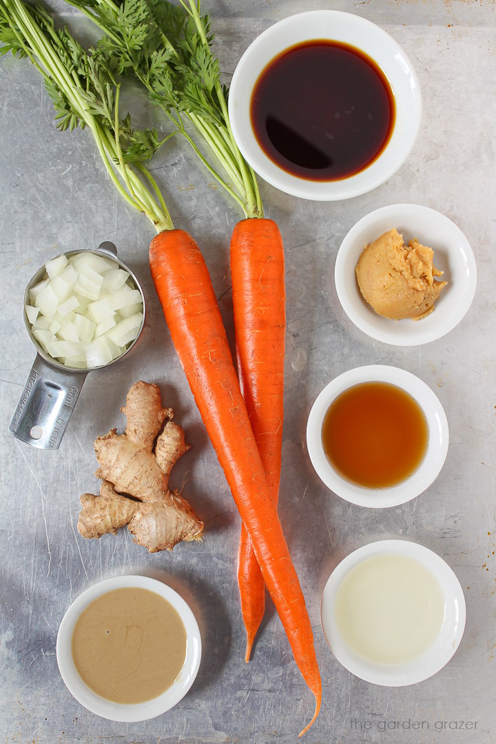 Tamari, onion, ginger, tahini, and fresh ingredients laid out on a metal tray