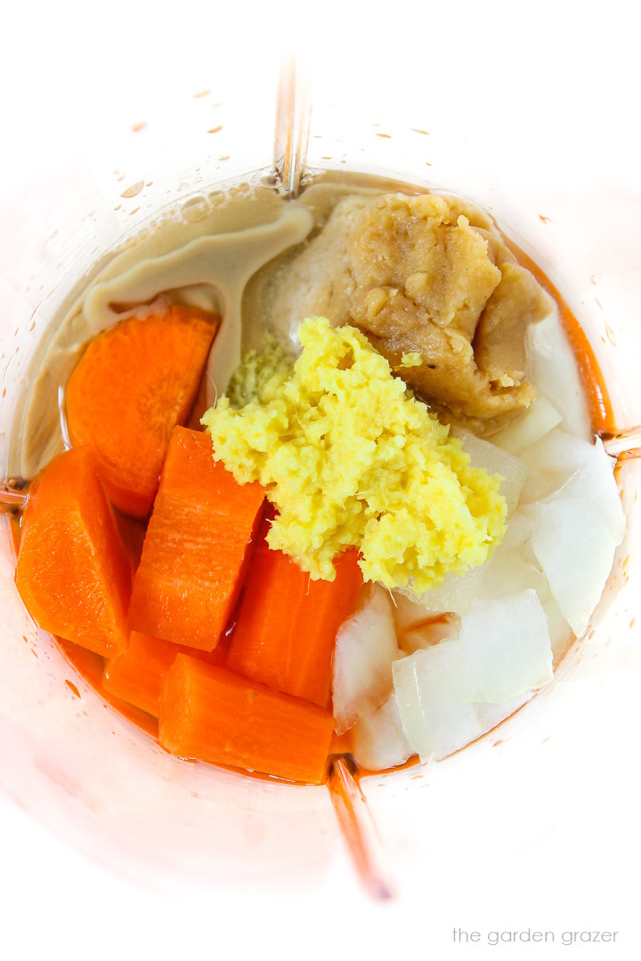 Overhead view of dressing ingredients in a blender cup before blending