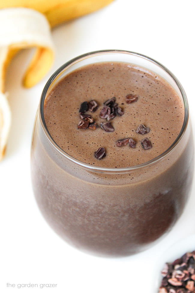 Overhead view of chunky monkey smoothie topped with cacao