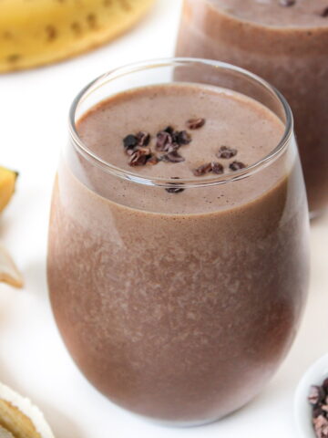 Chunky monkey smoothie in a glass with banana