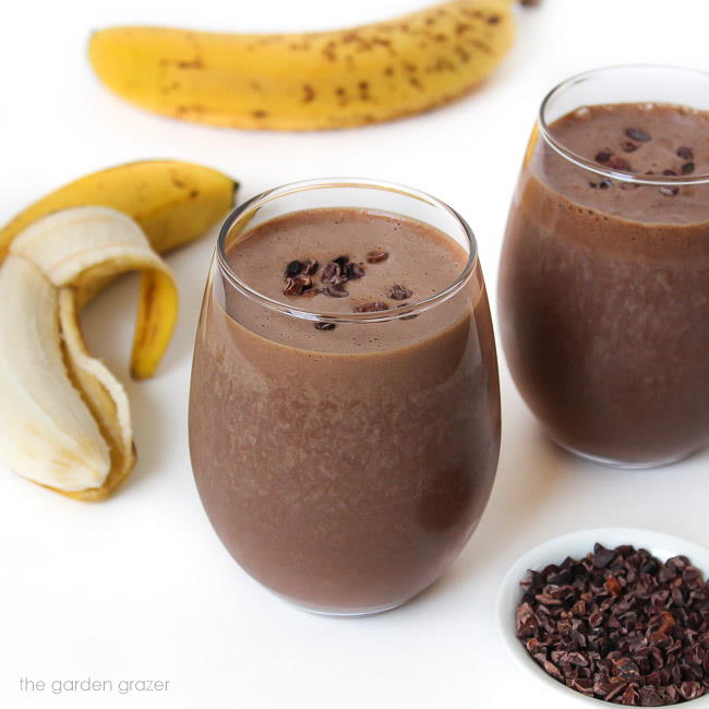 Two glasses of chocolate smoothie with banana and cacao