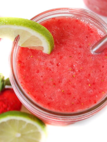 Strawberry lime watermelon slush in a glass with straw